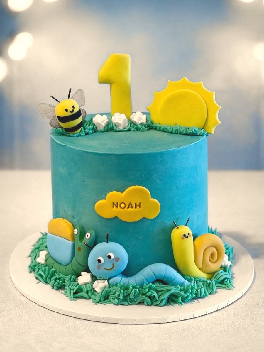 First birthday cake with hand-modelled garden creatures