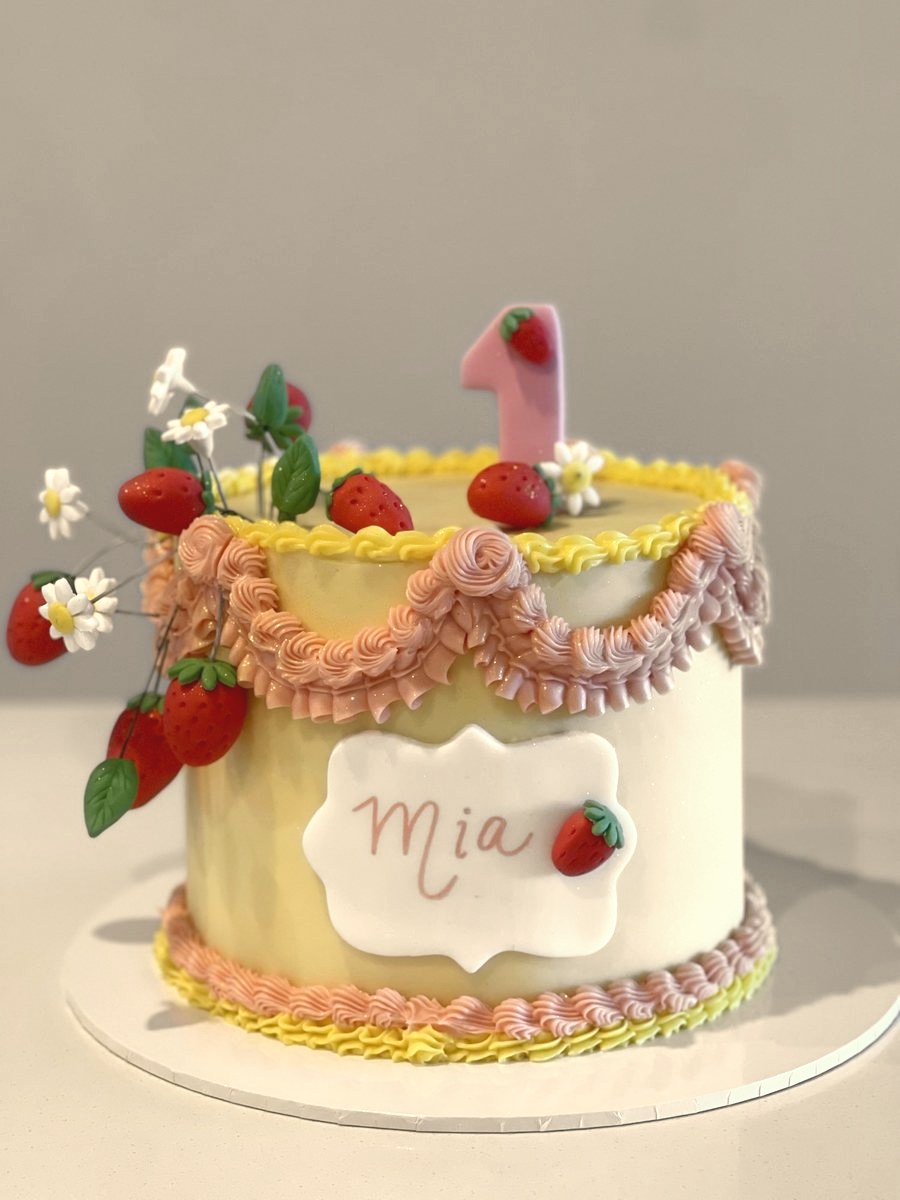 Vintage piped cake with strawberries and wildflowers
